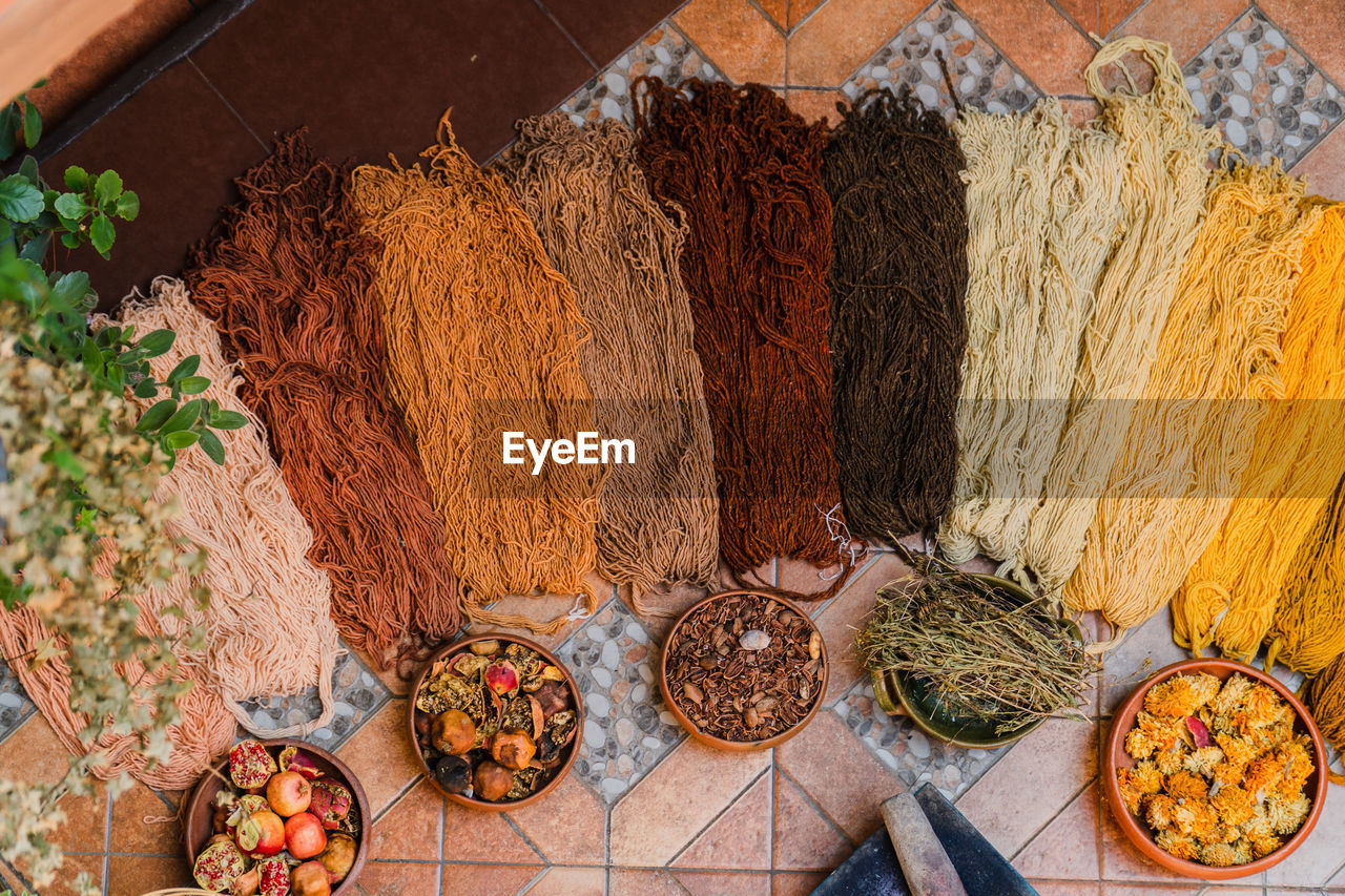Handmade wool with natural dyes made of fruit displayed in bright earth colors in a textile factory.