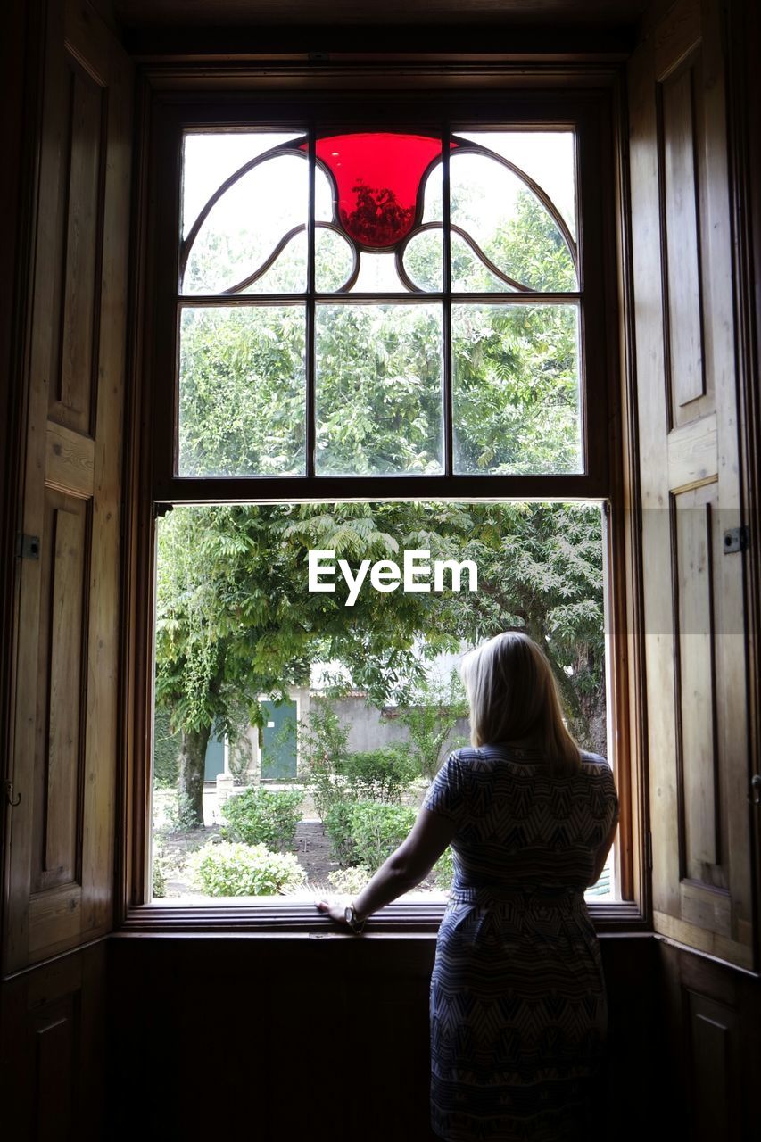 Woman looking through window