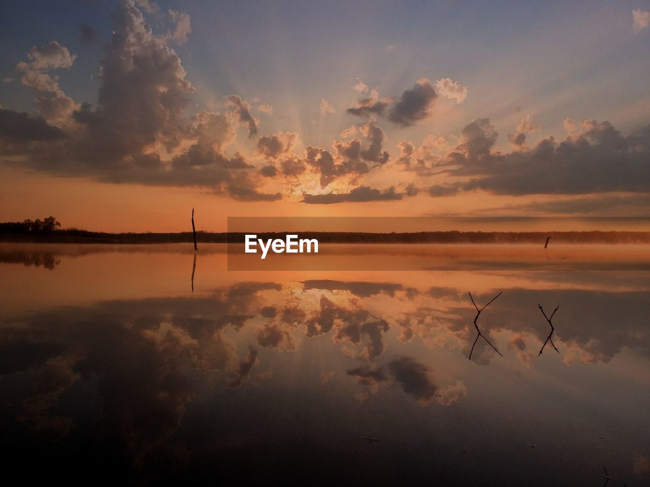 Scenic view of lake against sky during sunset