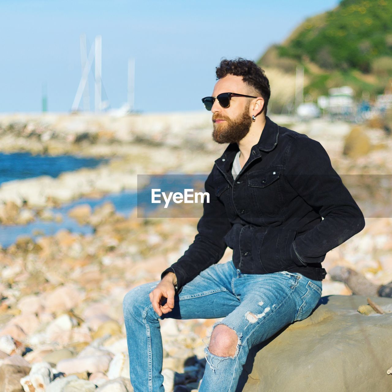 Man sitting by the beach