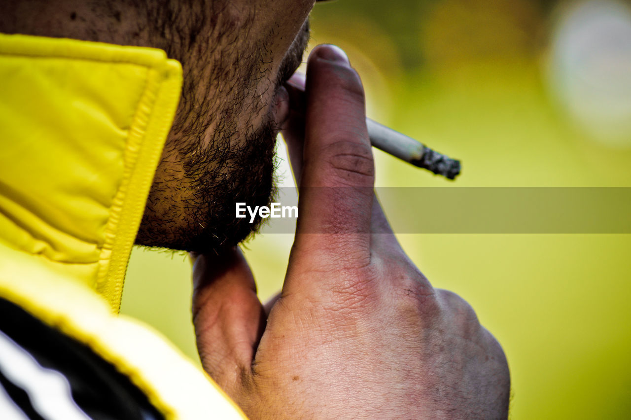 Cropped image of man smoking cigarette