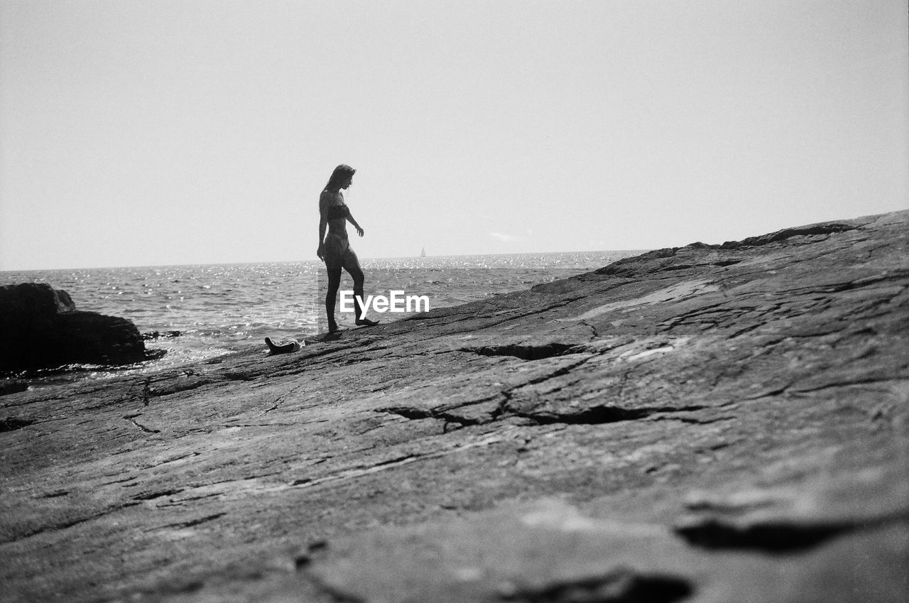 Rear view of man walking on rock