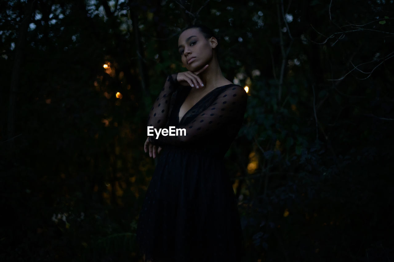 WOMAN LOOKING AWAY IN FOREST