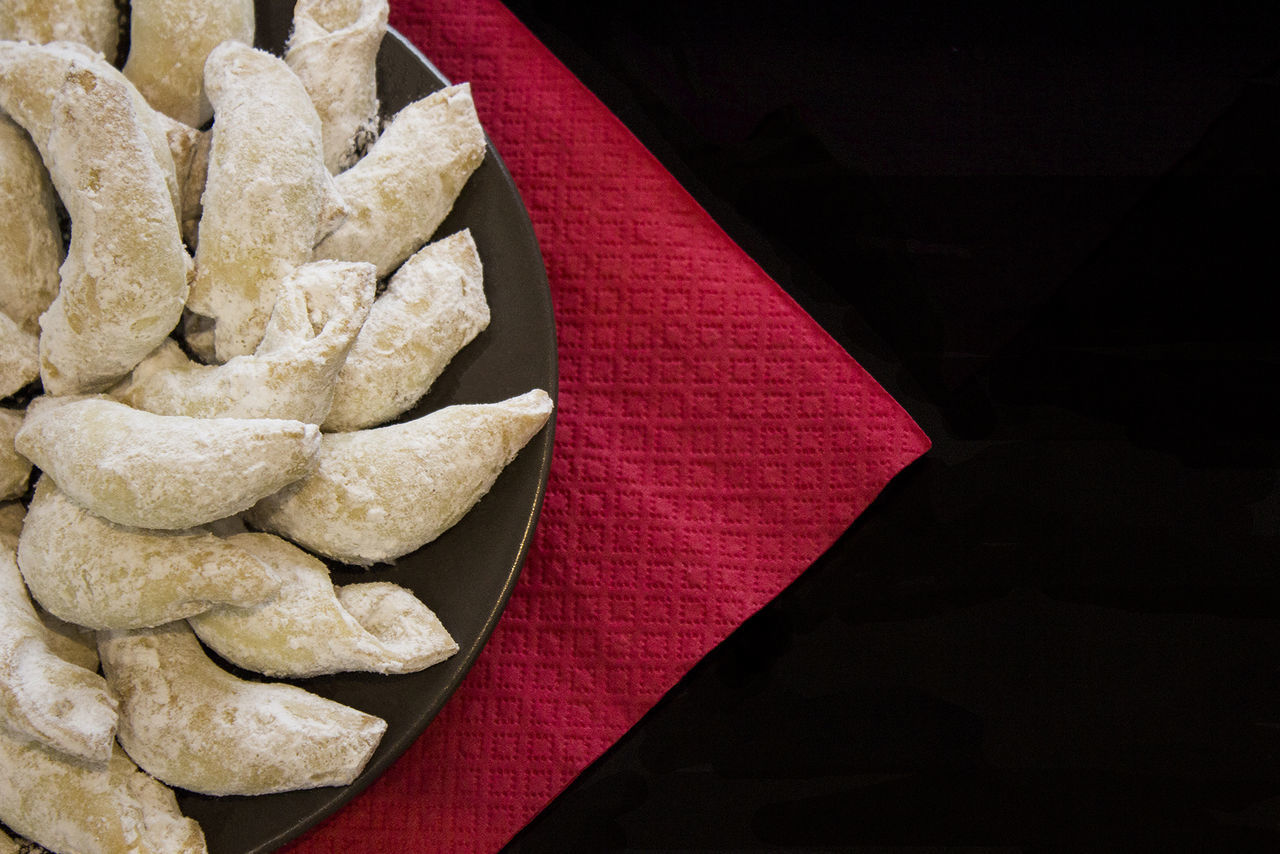 High angle view of sweet food in plate on black background