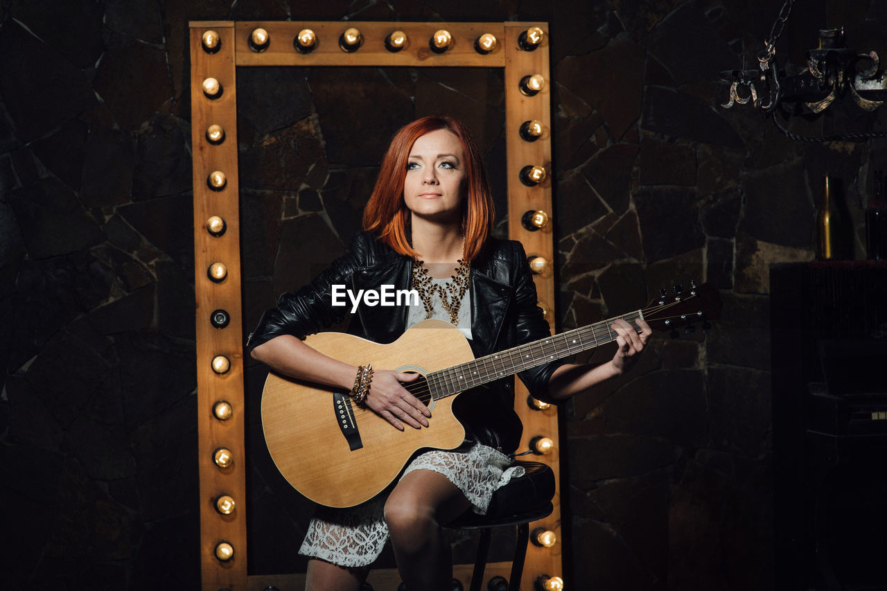 FULL LENGTH PORTRAIT OF WOMAN WITH GUITAR