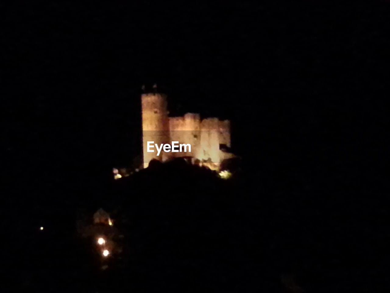 LOW ANGLE VIEW OF ILLUMINATED BUILT STRUCTURE AT NIGHT