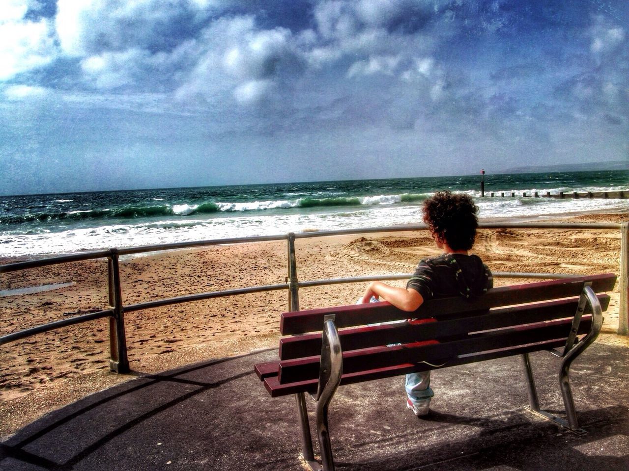 Man looking at sea from bench