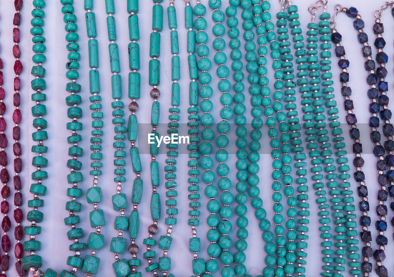 High angle view of necklaces arranged on table for sale in store