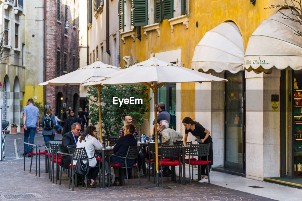GROUP OF PEOPLE AT CAFE