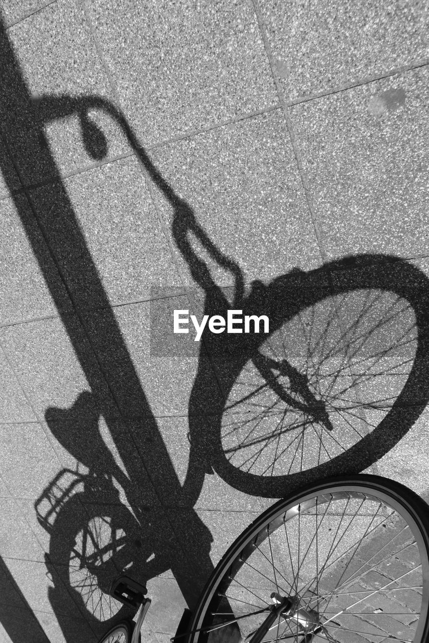 Shadow of bicycle on sidewalk