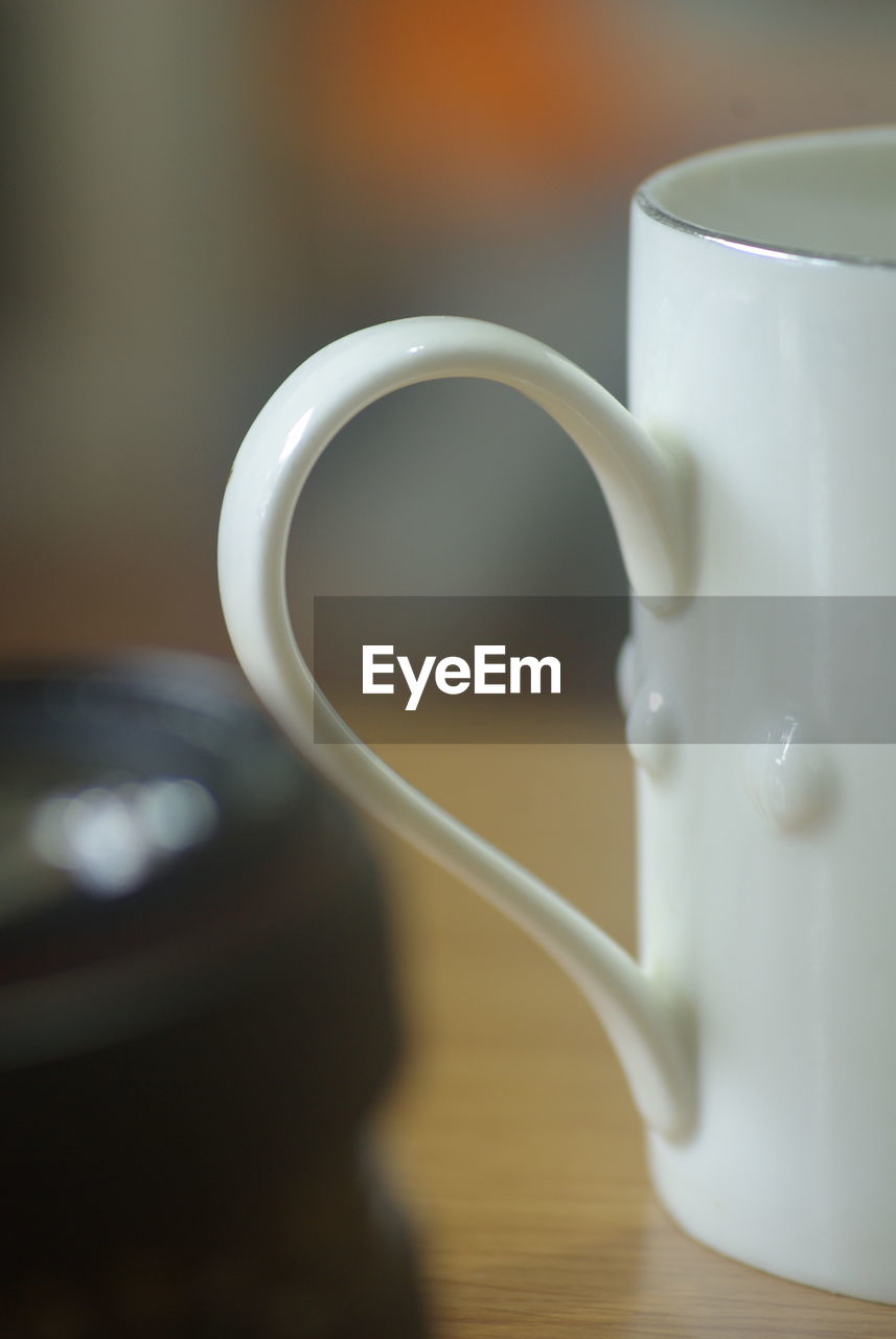 CLOSE-UP OF CUP OF COFFEE ON TABLE