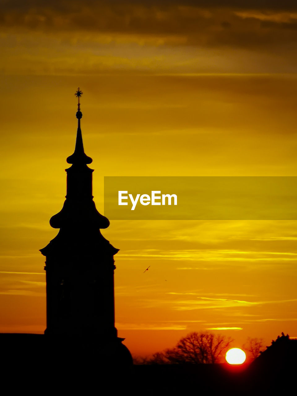 Silhouette building against sky during sunset