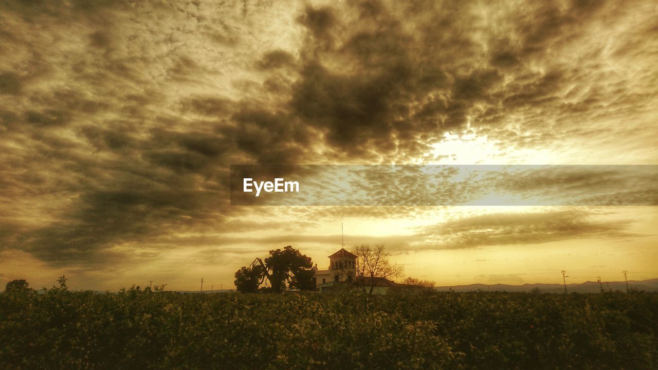 Scenic view of landscape against cloudy sky