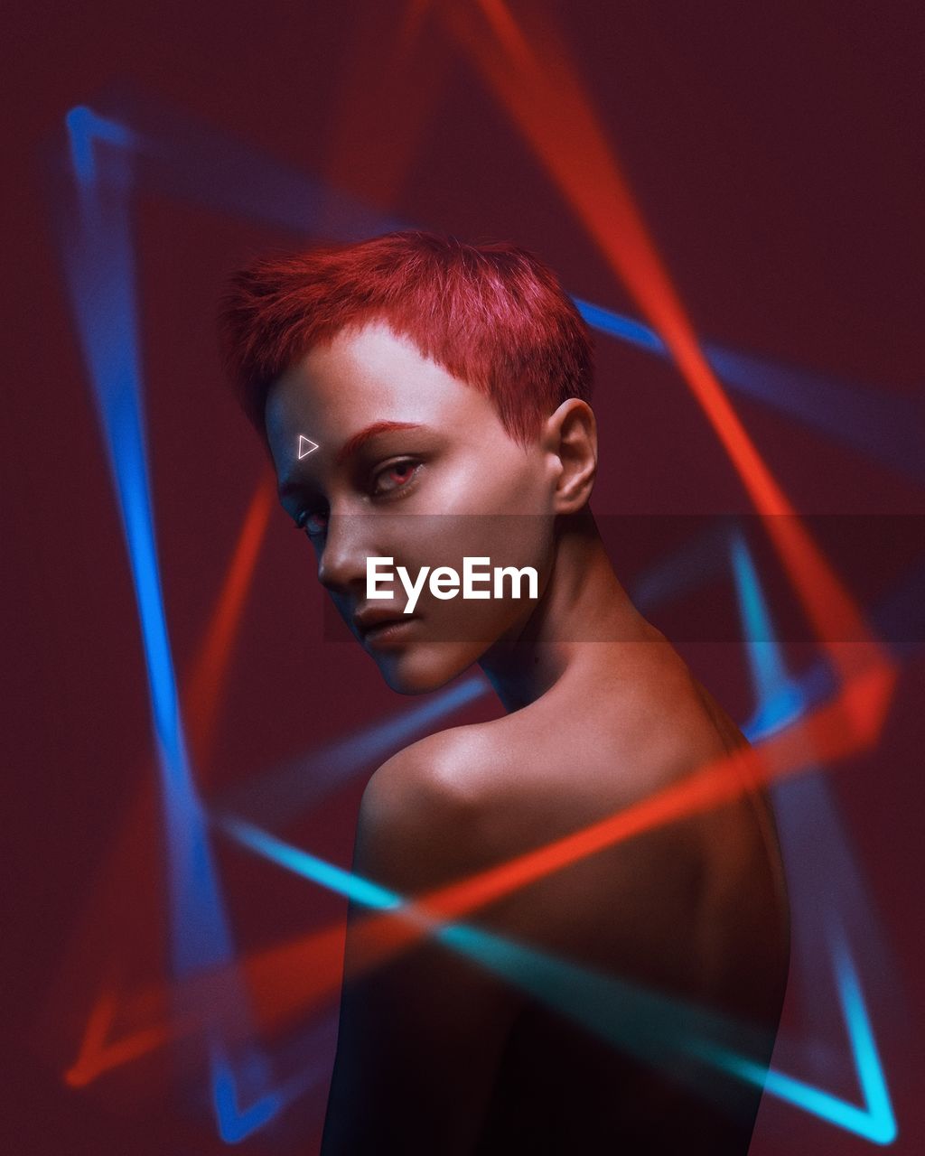 Portrait of young woman amidst illuminated lights