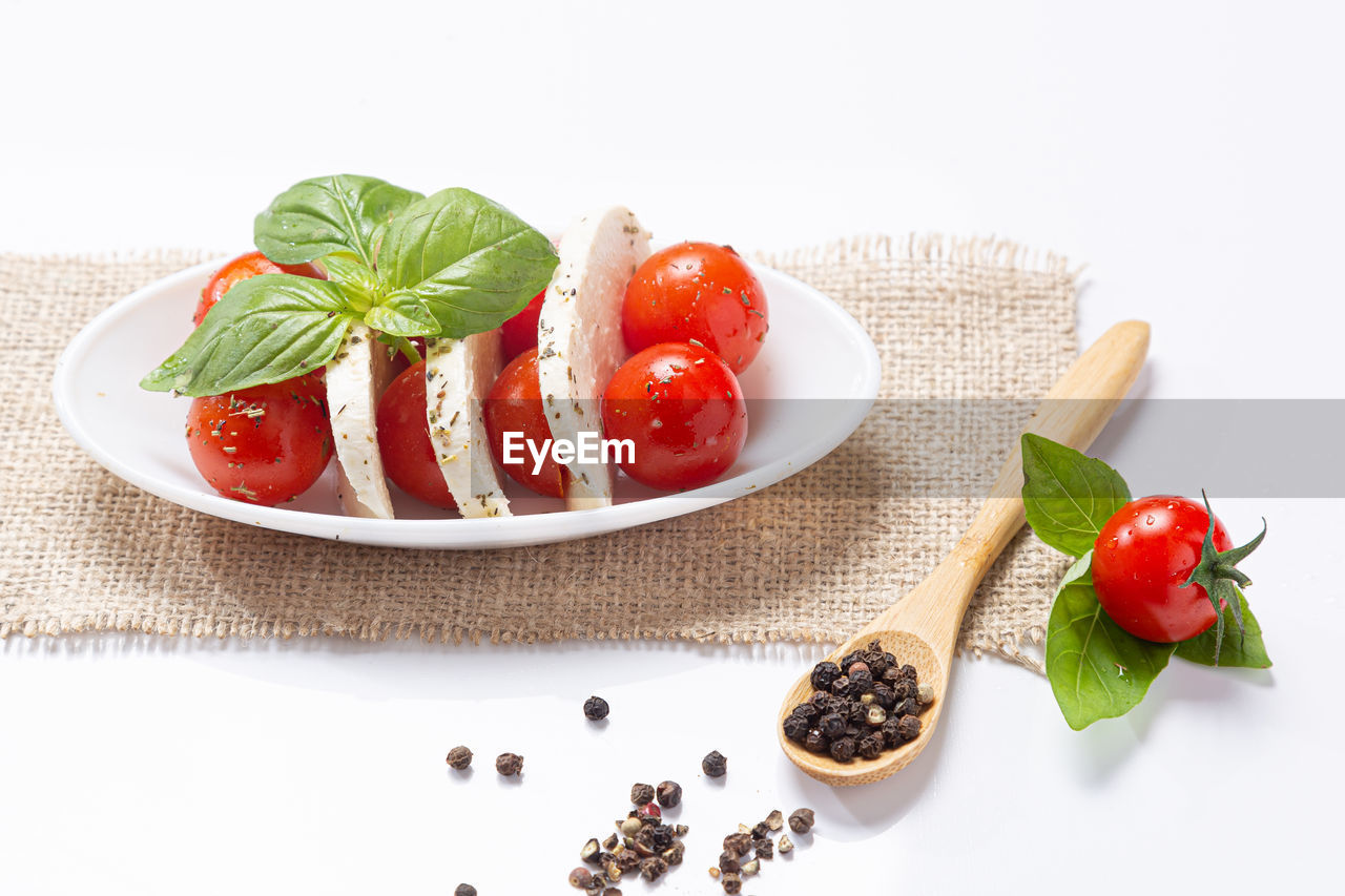 food and drink, food, fruit, healthy eating, freshness, wellbeing, vegetable, dish, studio shot, berry, tomato, herb, red, indoors, no people, produce, ingredient, basil, spice, strawberry, plate, leaf, plant, dairy, white background, still life, sweet food, italian food, cherry tomato, plant part