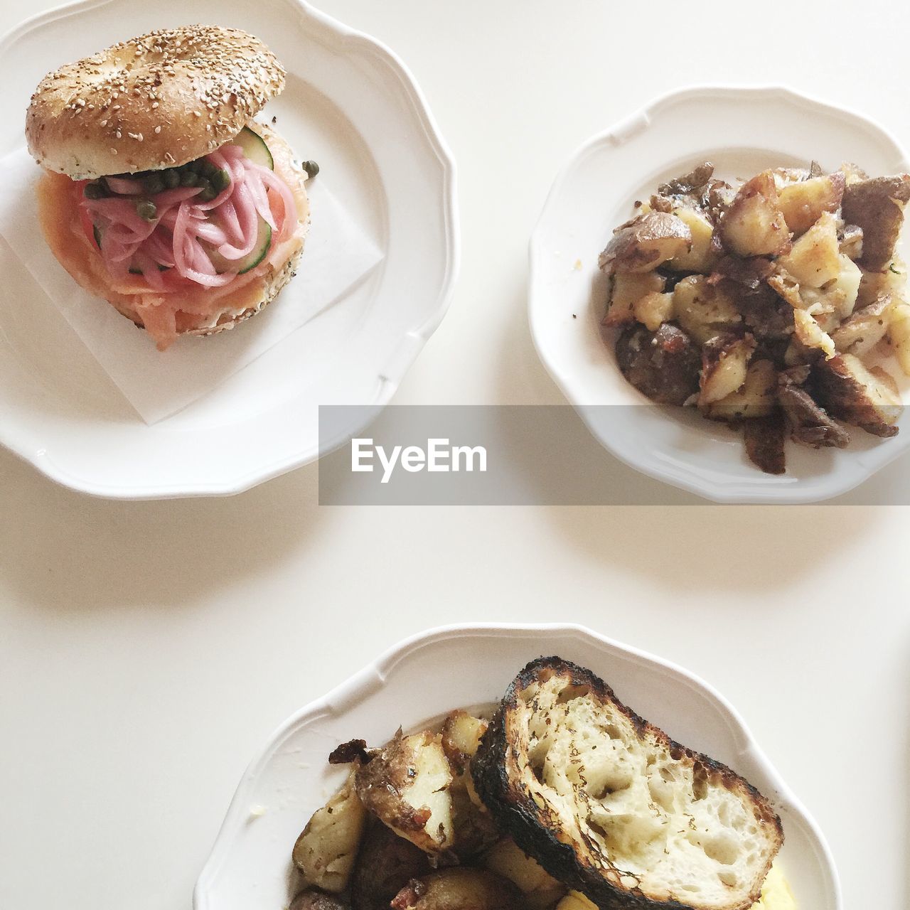 Close-up of burger served with fried potato on table