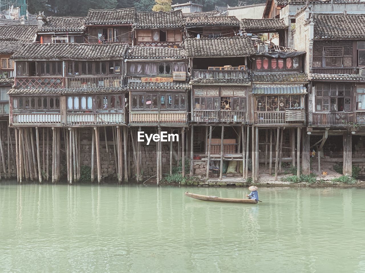 BOATS IN RIVER AGAINST BUILDINGS