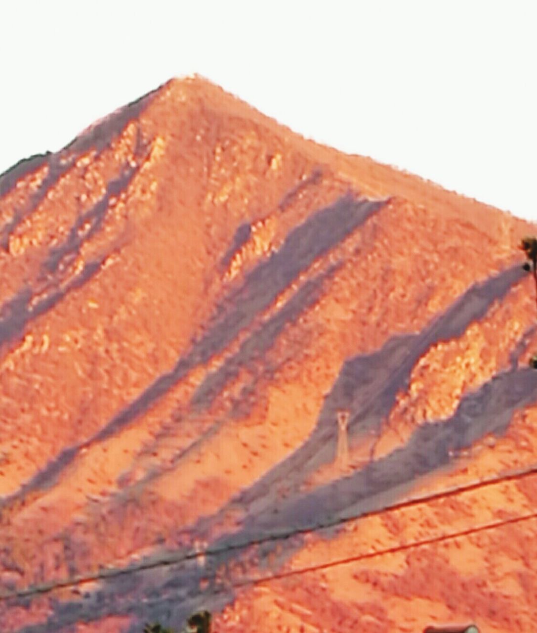 CLOSE-UP OF MOUNTAIN AGAINST SKY