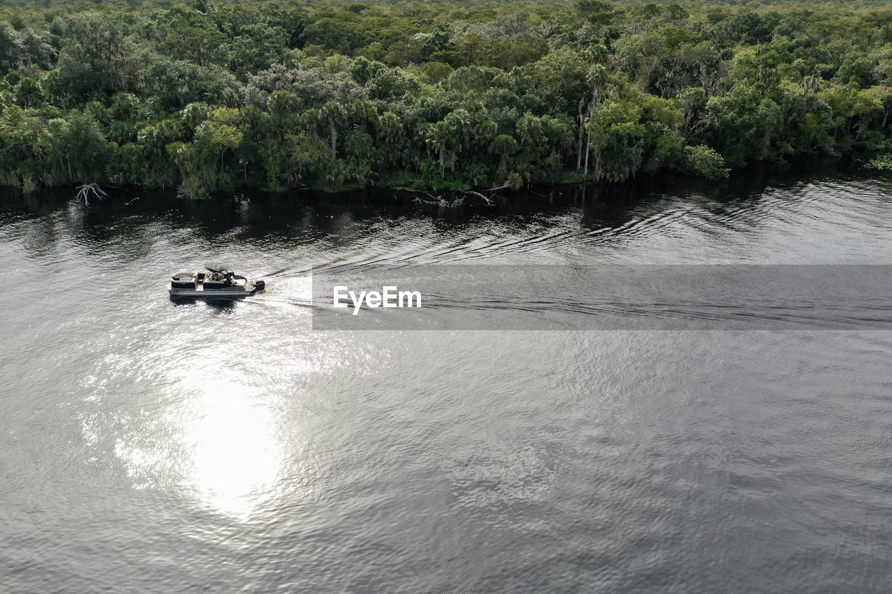 HIGH ANGLE VIEW OF MEN SAILING ON RIVER