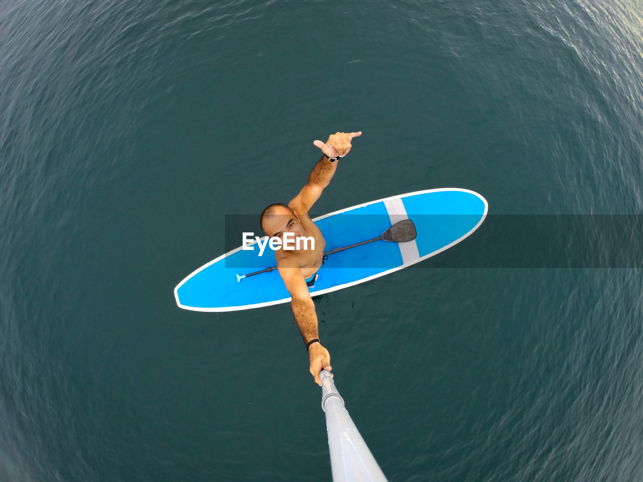 High angle view of man with boat in sea