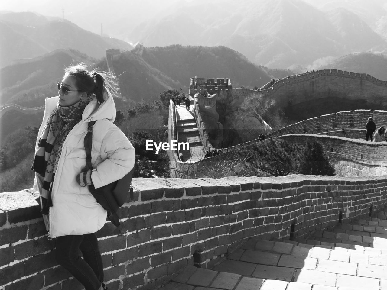 Woman standing on the great wall against mountain range