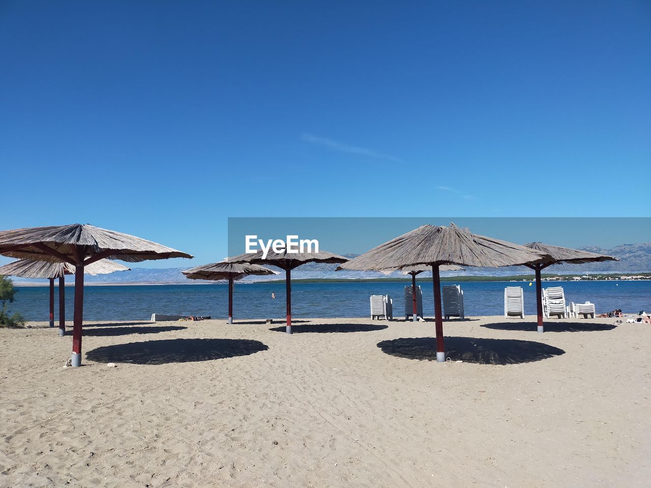 GAZEBO AT BEACH AGAINST CLEAR BLUE SKY
