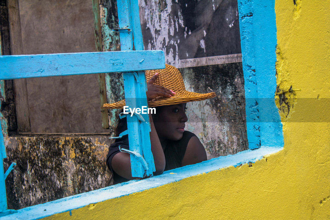 Woman standing by wall