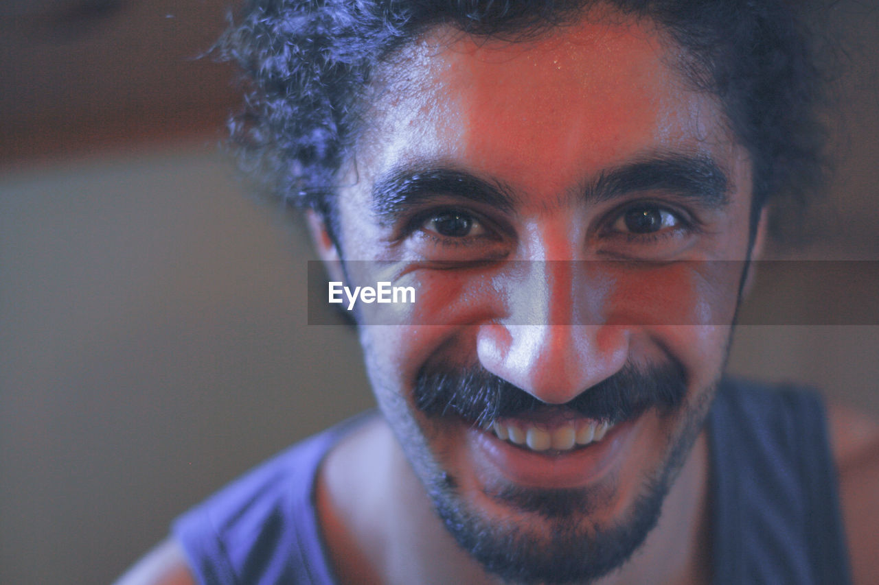 Close-up portrait of smiling young man