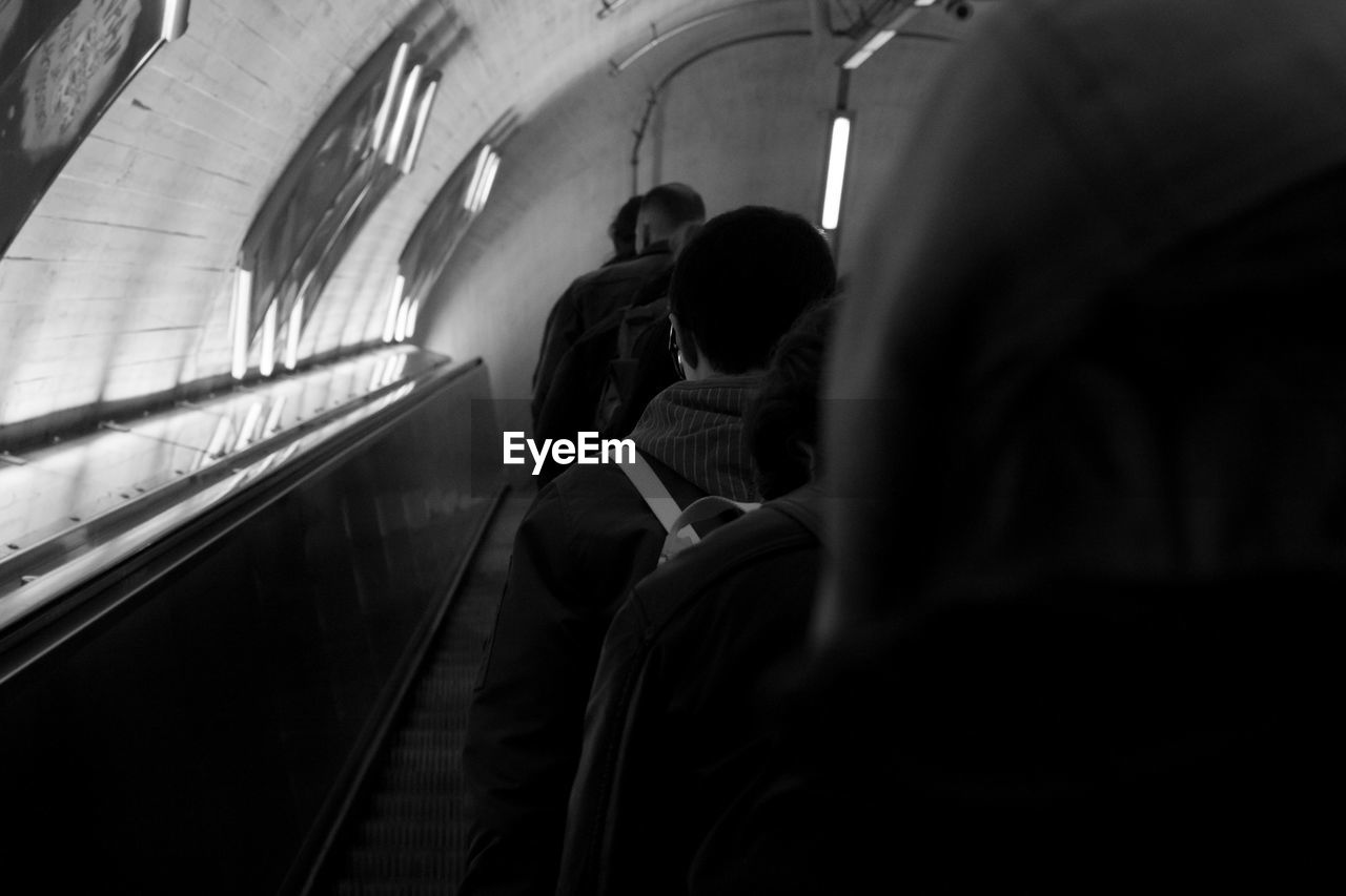 Rear view of people walking in subway