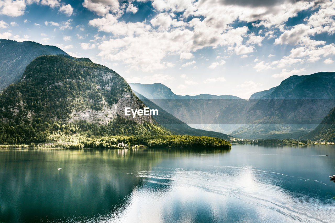 Scenic view of lake and mountains against sky