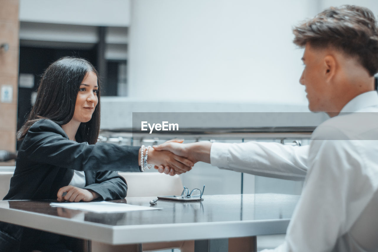 Business people shaking hand at office