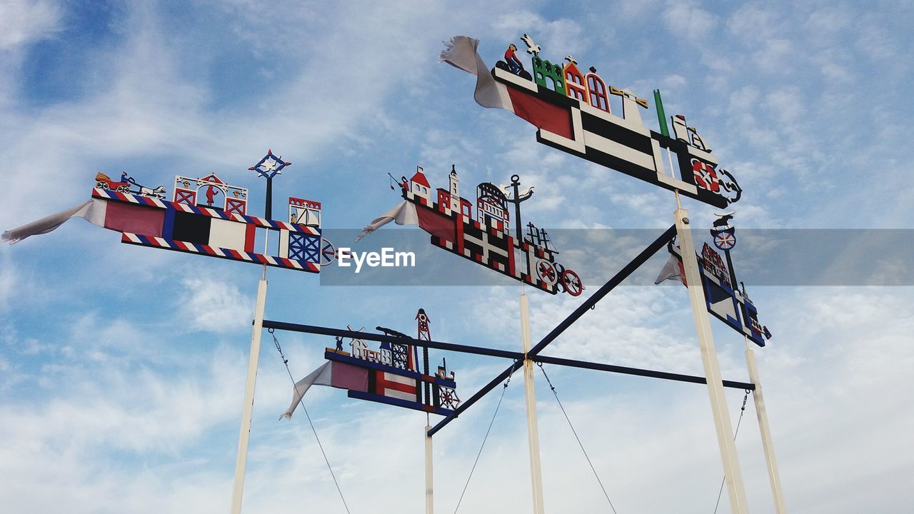 Low angle view of colorful weather vane against sky