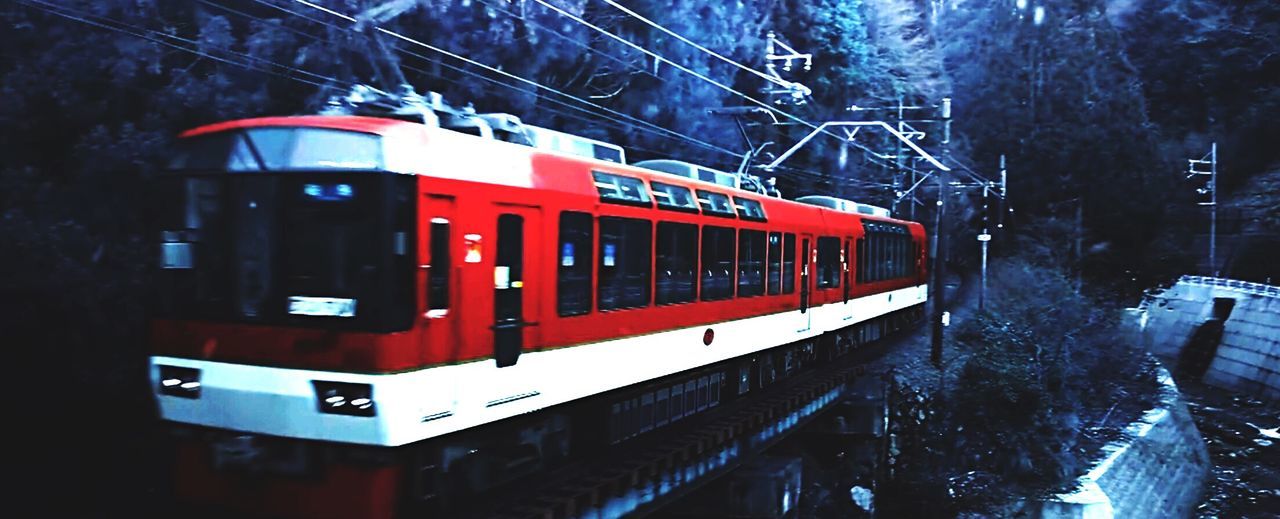 CLOSE-UP OF RED CAR ON ROAD