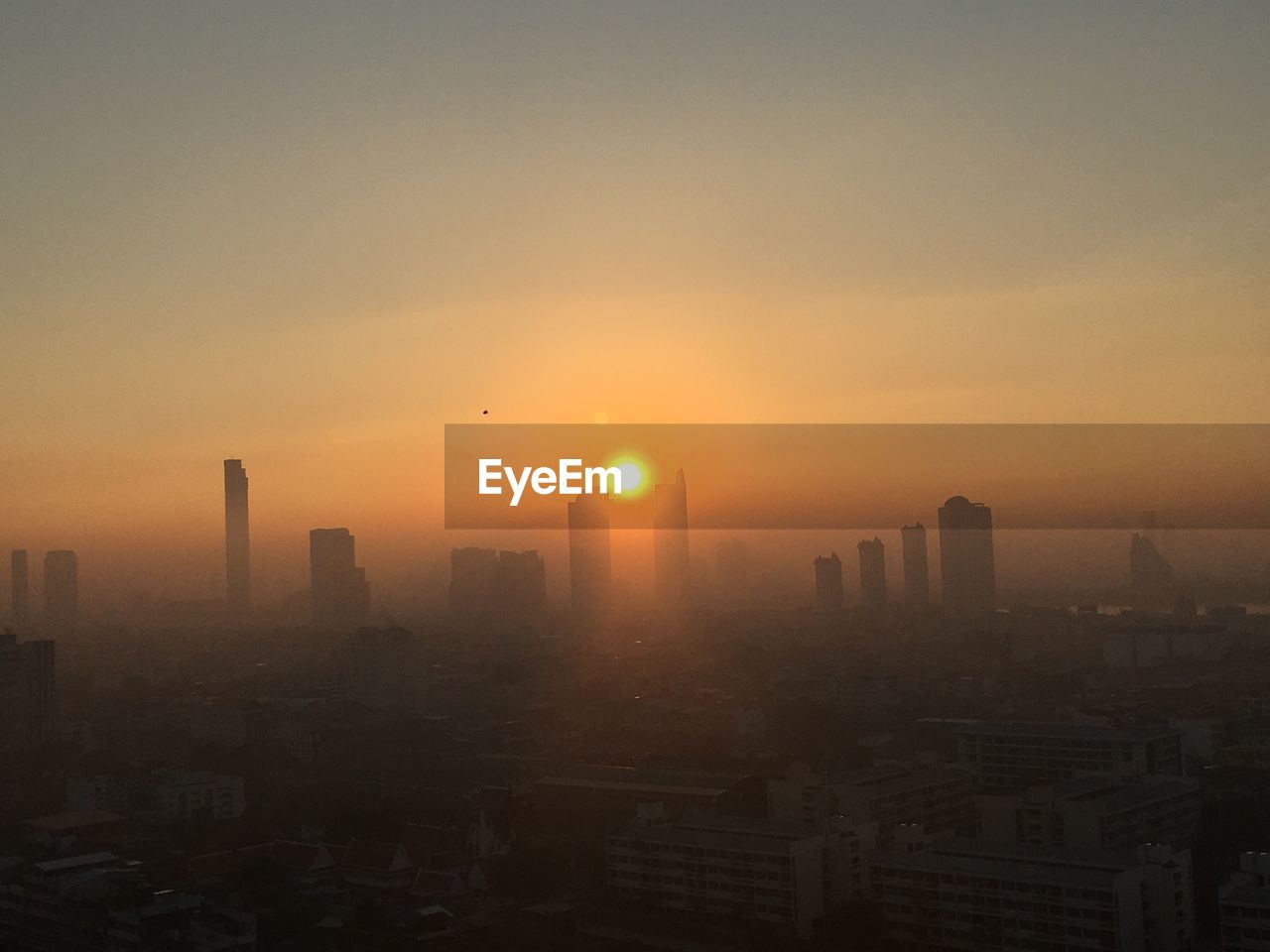 CITY BUILDINGS AGAINST SKY DURING SUNSET