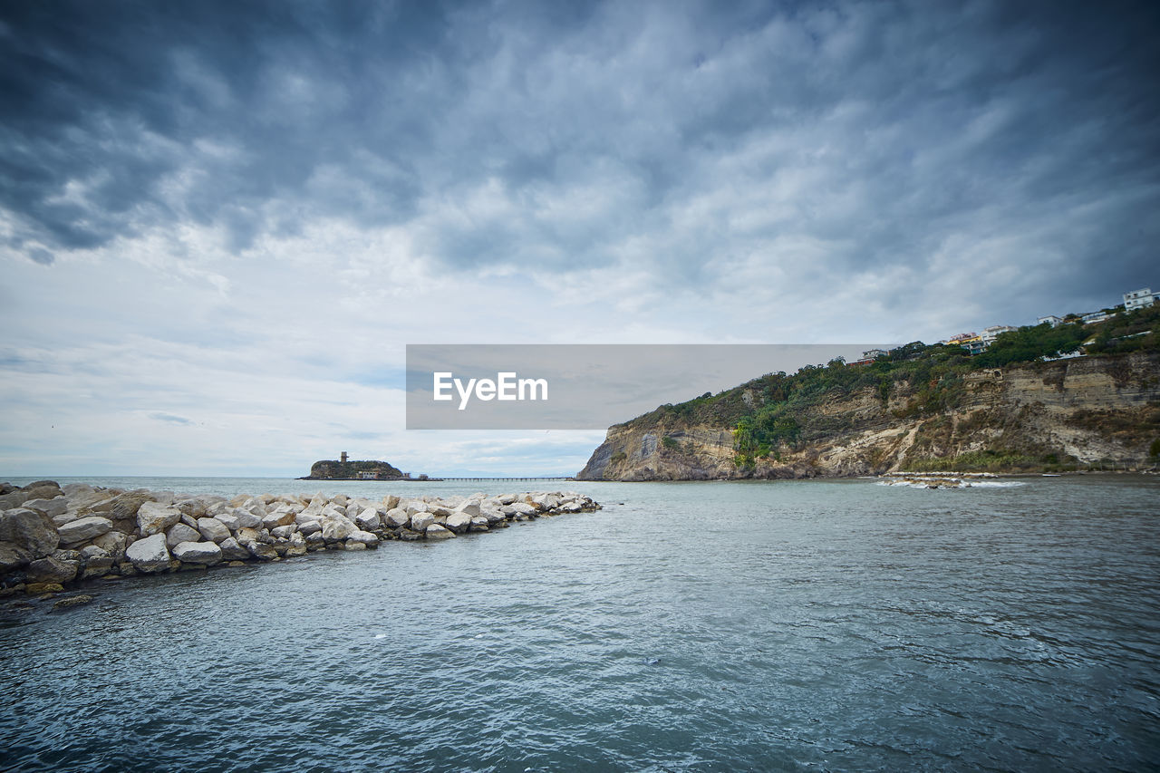 Scenic view of sea against cloudy sky