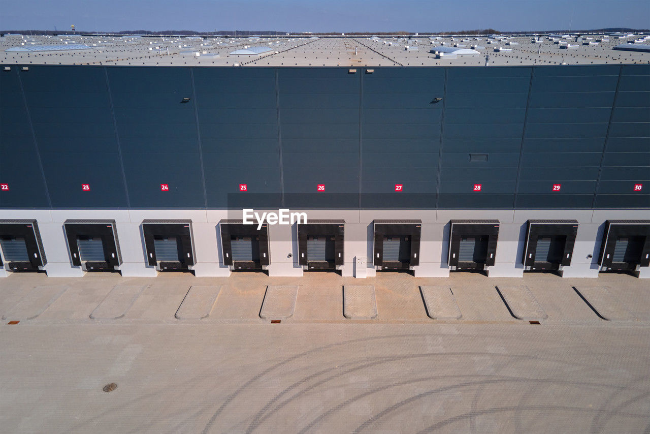 Logistics warehouse exterior with loading platforms, aerial view