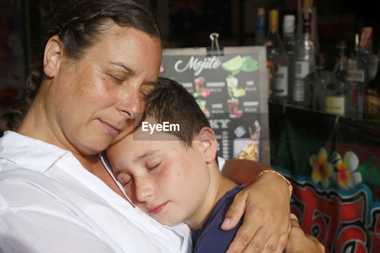 Close-up of mother embracing boy