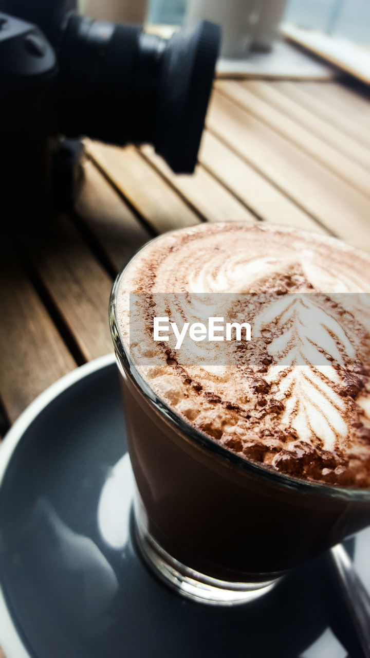 CLOSE-UP OF COFFEE CUP ON TABLE