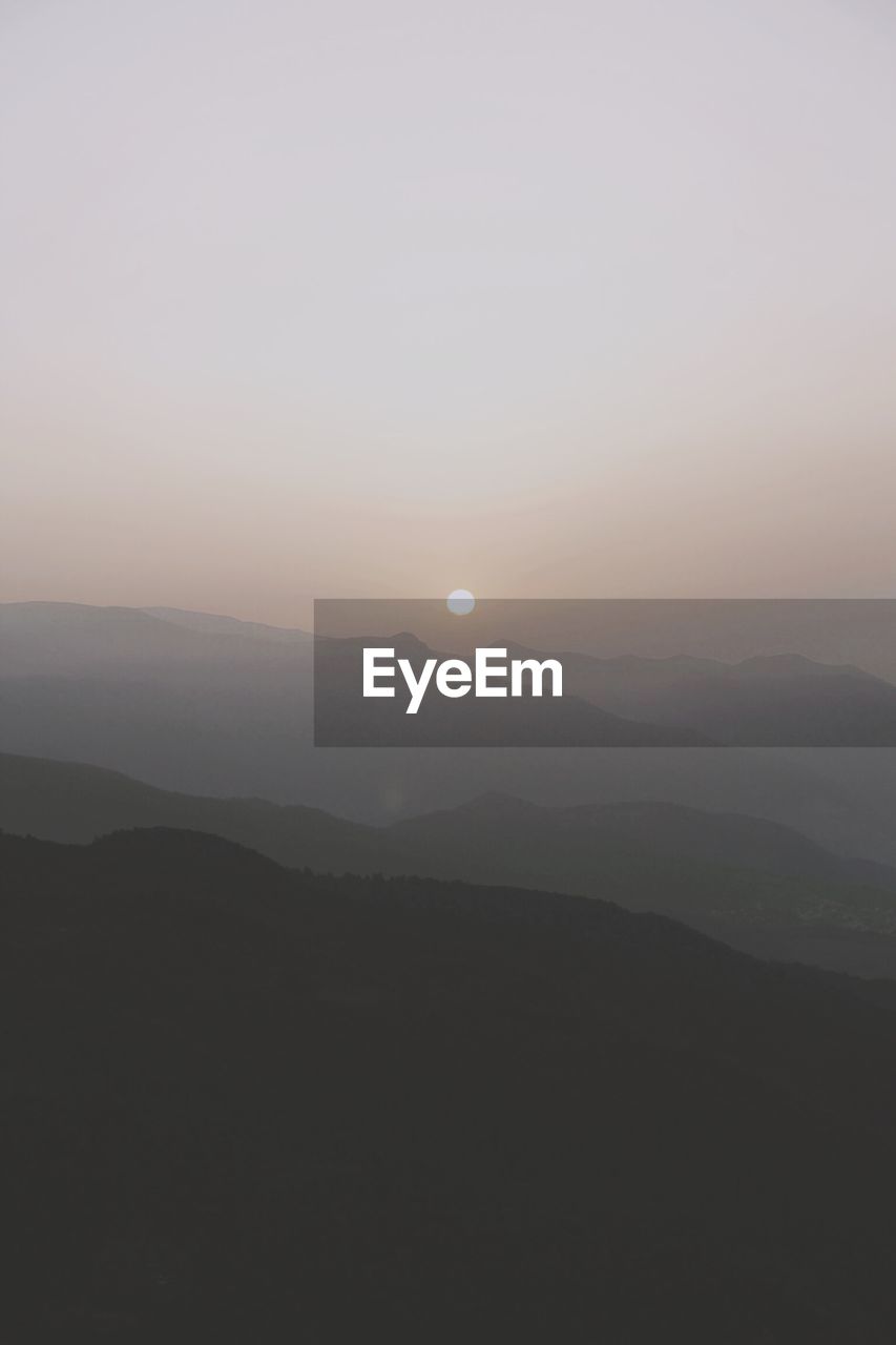 Scenic view of silhouette mountains against sky during sunset