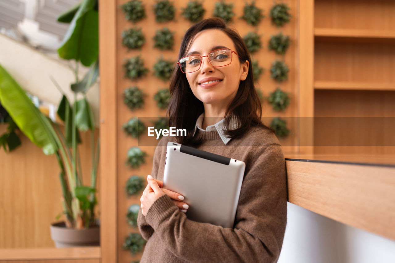 portrait of young woman using digital tablet