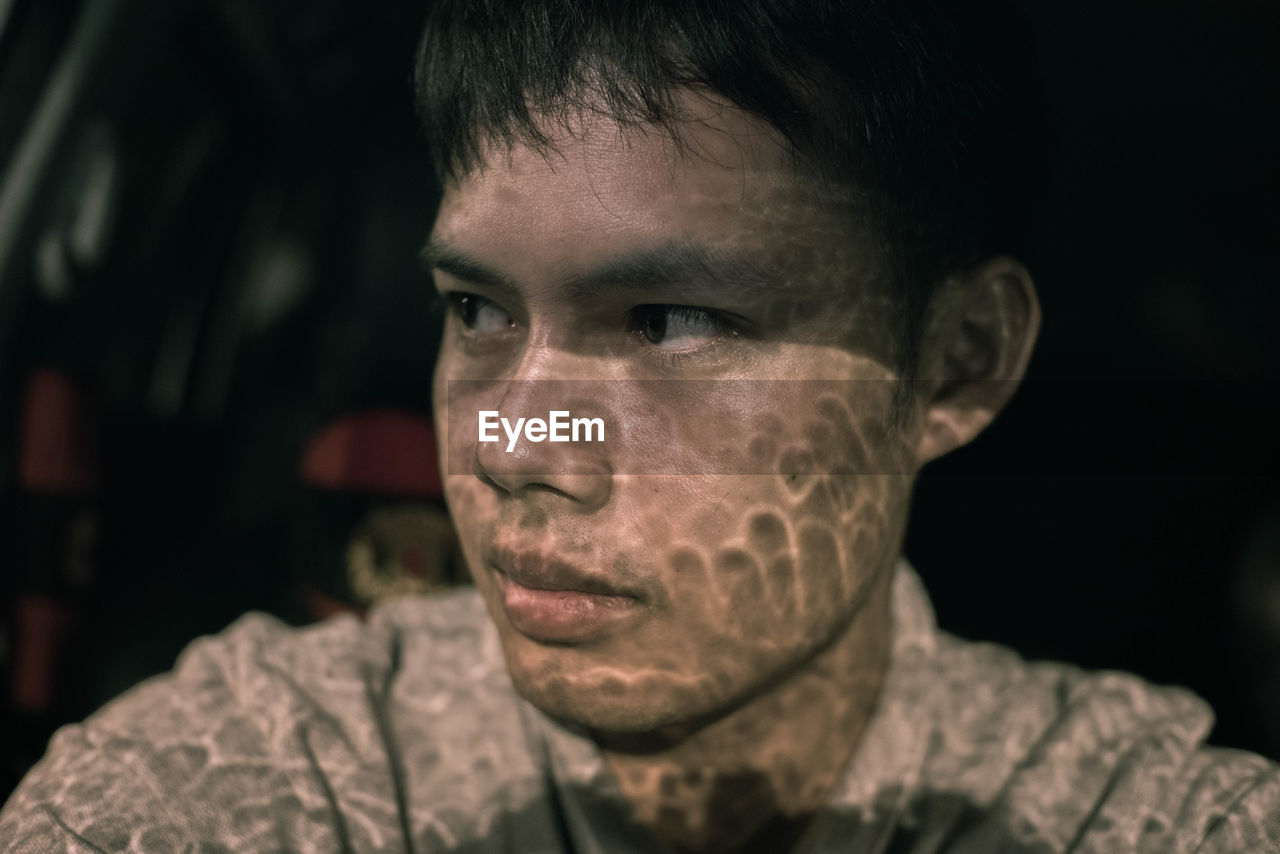 Sunlight falling on young man in car