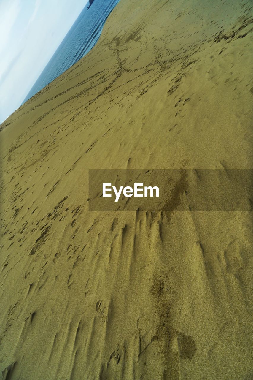 CLOSE-UP OF SAND ON BEACH