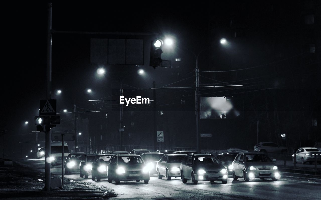 Cars moving on city street at night