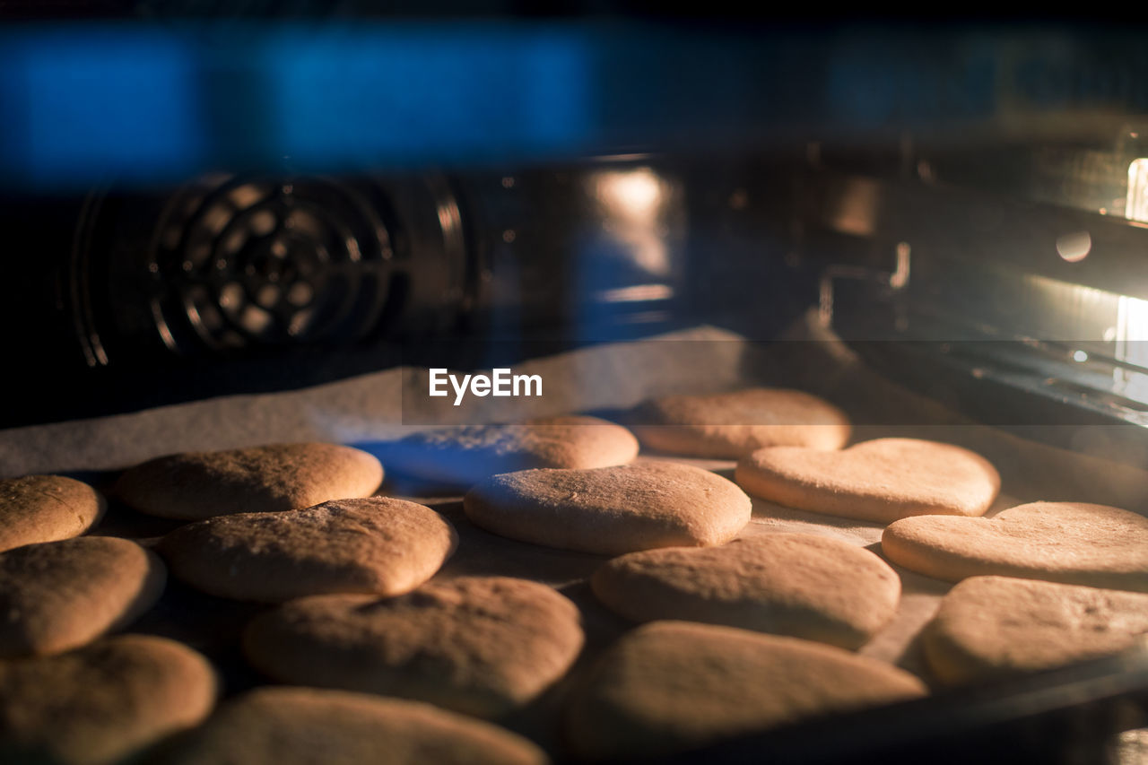 Christmas cookies baking in the oven. christmas baking. gingerbread biscuits on baking tray.