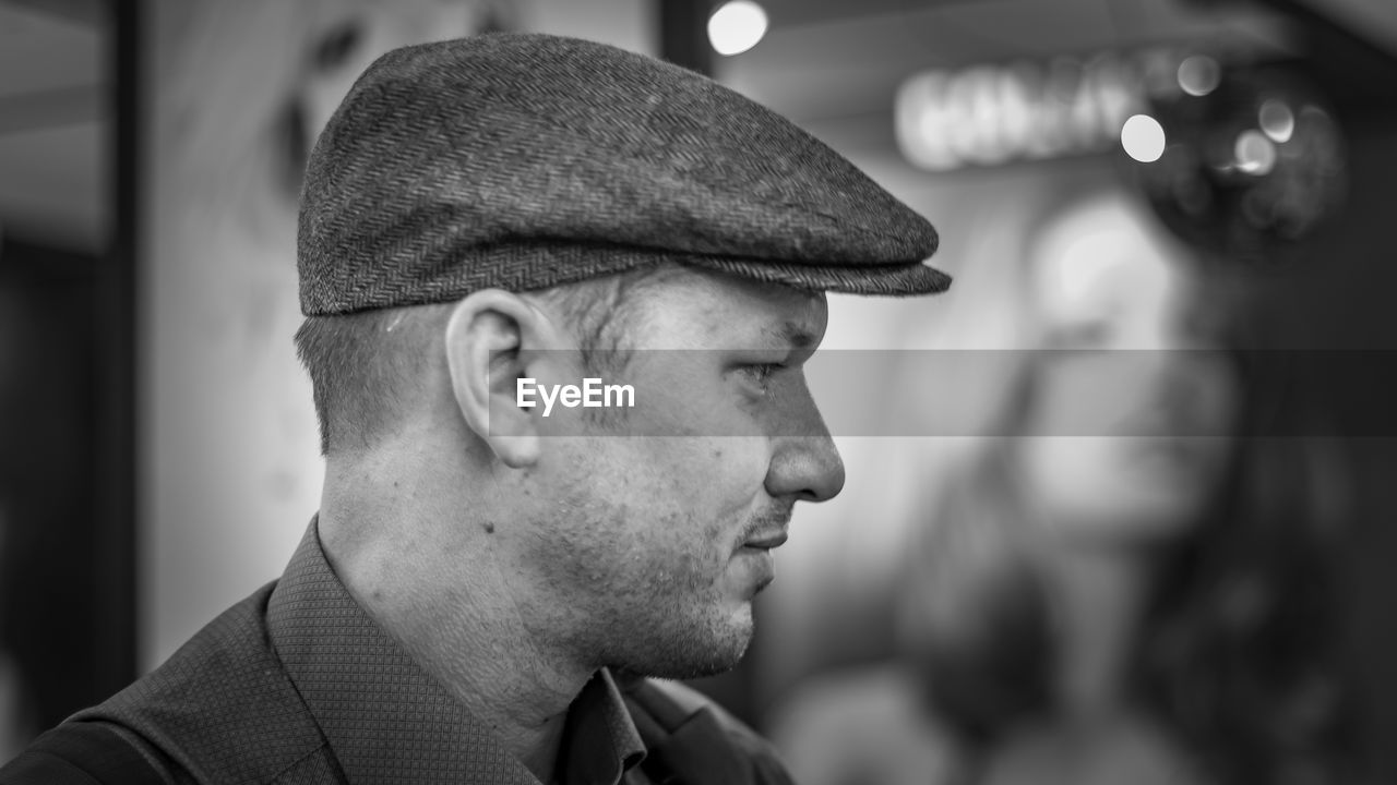 Side view of man wearing flat cap