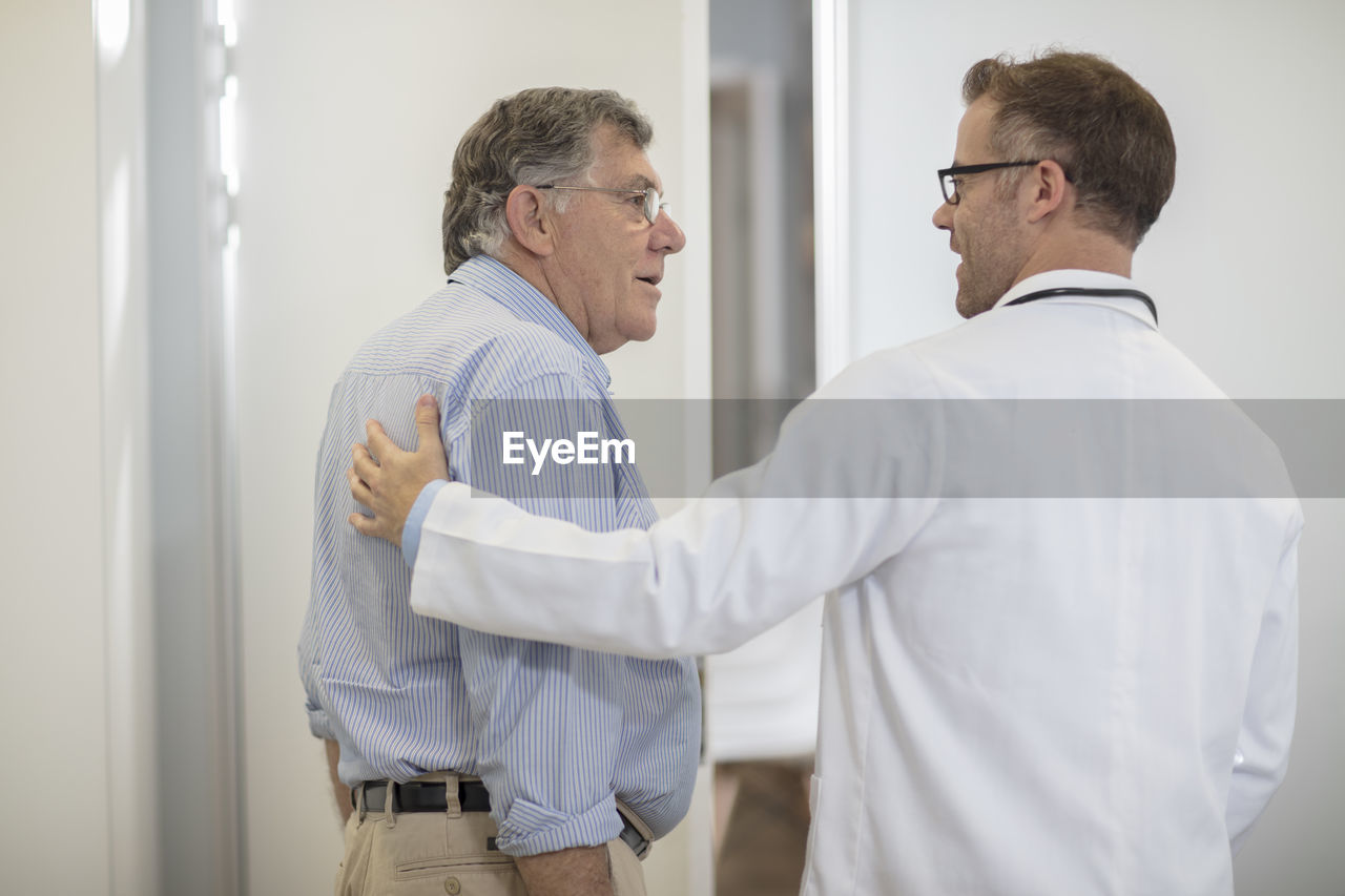 Doctor talking to senior patient in medical practice