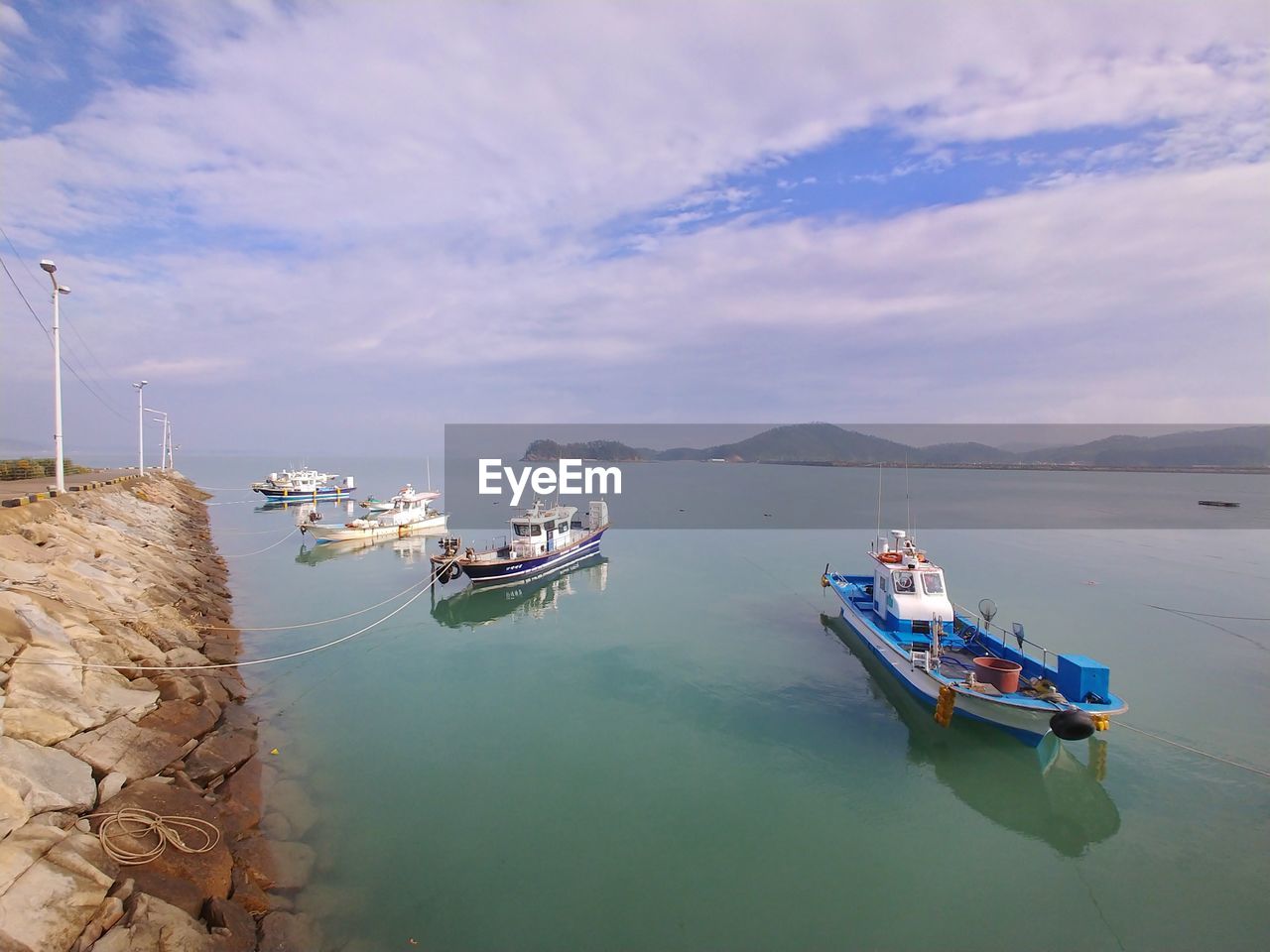 Boats moored in sea against sky