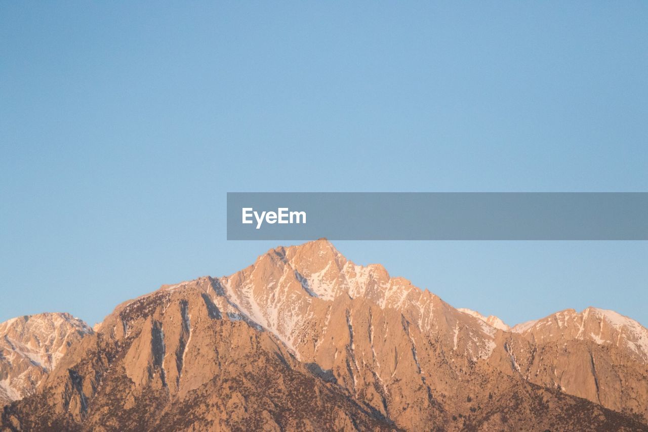 SCENIC VIEW OF MOUNTAIN AGAINST BLUE SKY