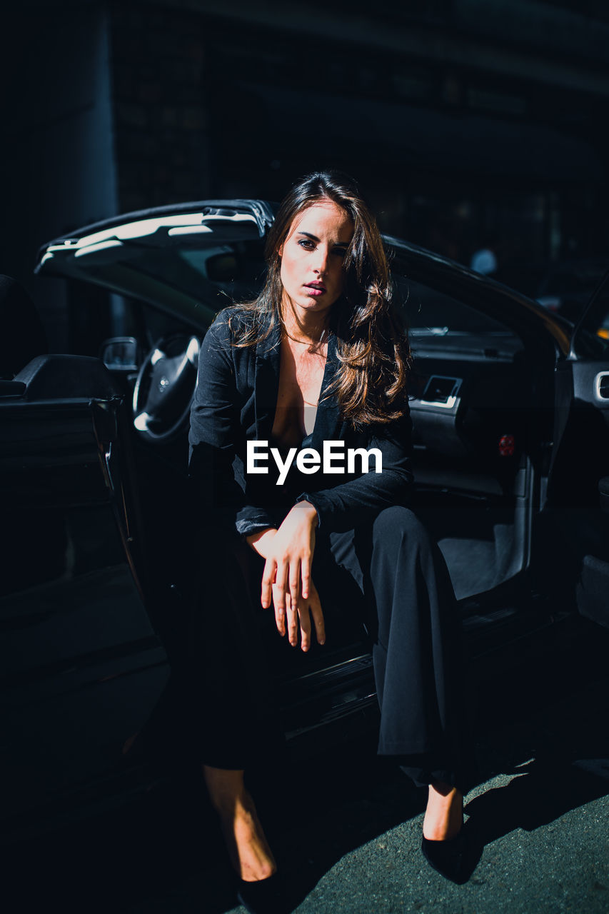 Full length of woman sitting in car