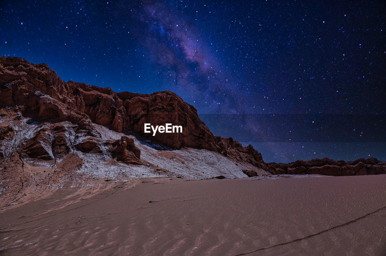 Scenic view of desert against sky at night